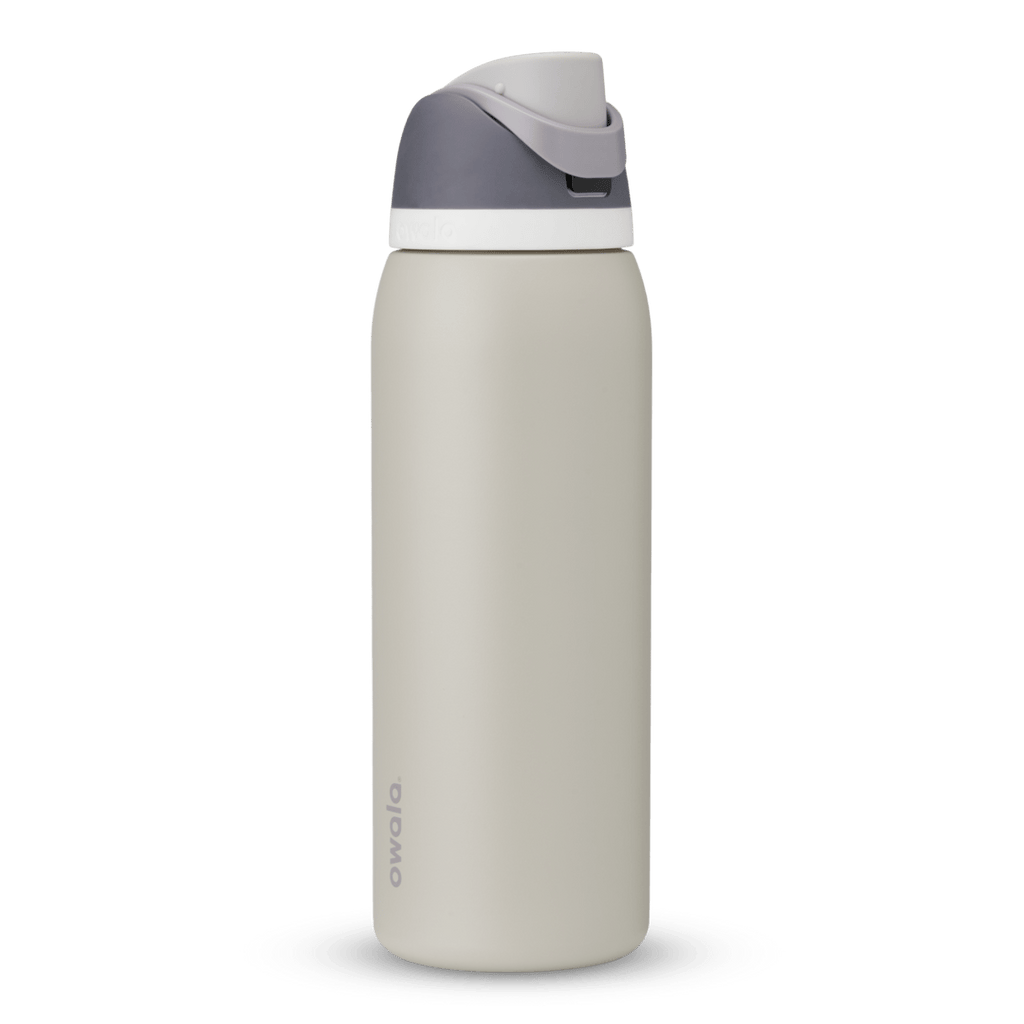Owala FreeSip 24oz in Out of the Blue, periwinkle blue insulated bottle with matching blue-lavender flip cap and carry loop