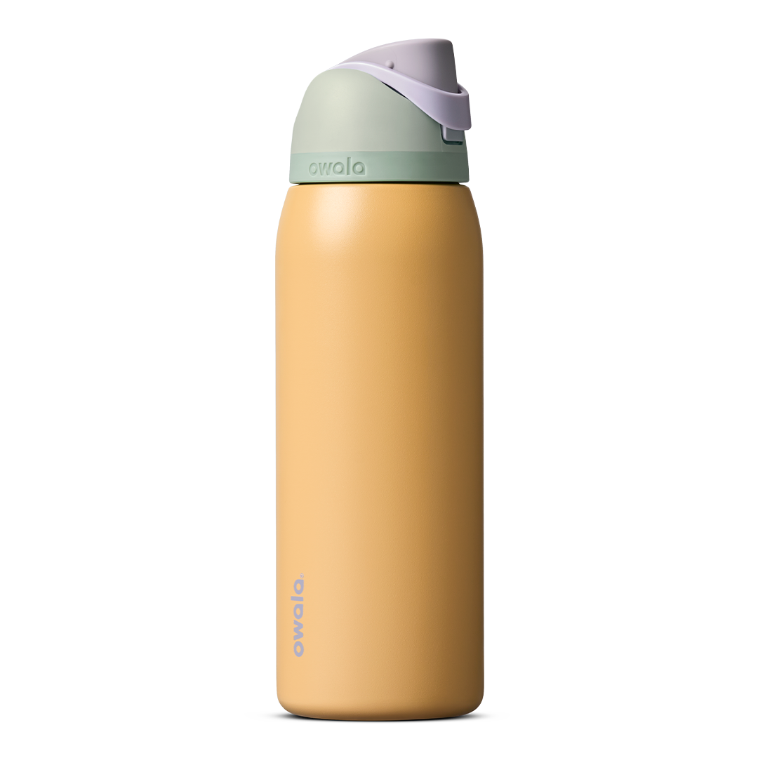 Owala FreeSip 24oz in Out of the Blue, periwinkle blue insulated bottle with matching blue-lavender flip cap and carry loop