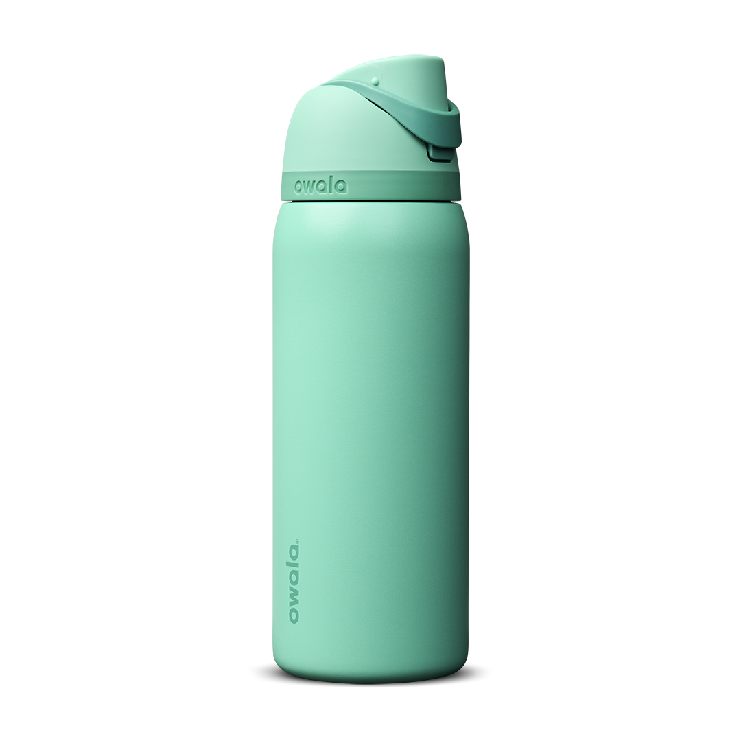 Owala FreeSip 24oz in Out of the Blue, periwinkle blue insulated bottle with matching blue-lavender flip cap and carry loop