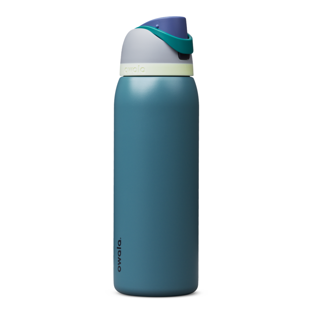 Owala FreeSip 24oz in Out of the Blue, periwinkle blue insulated bottle with matching blue-lavender flip cap and carry loop