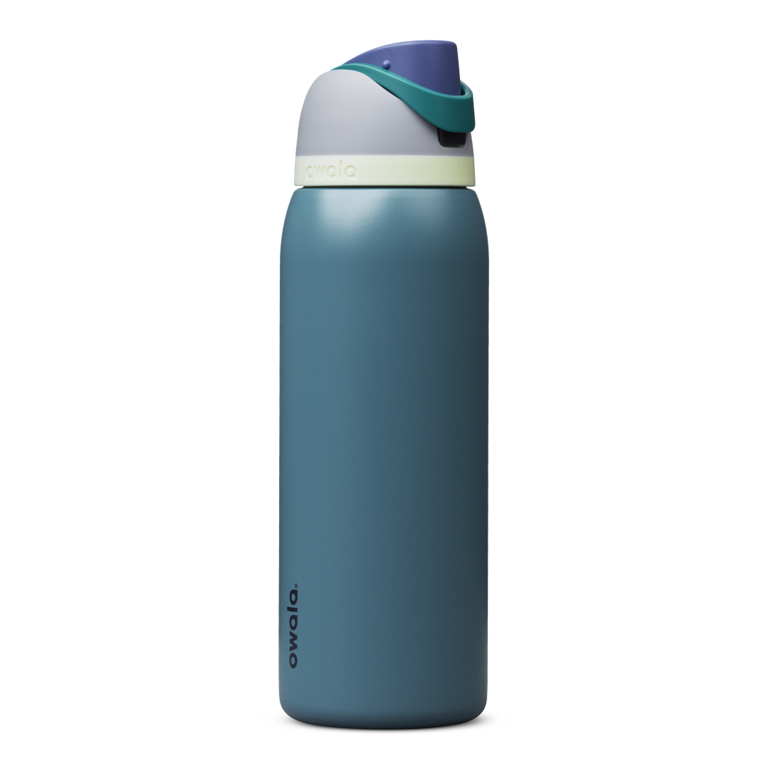 Owala FreeSip 24oz in Out of the Blue, periwinkle blue insulated bottle with matching blue-lavender flip cap and carry loop