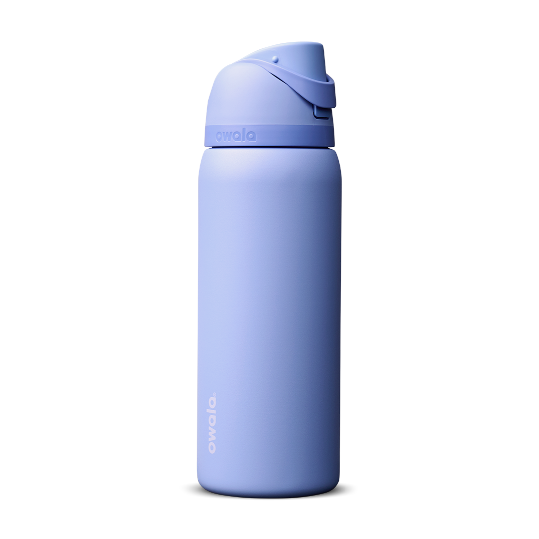 Owala FreeSip 24oz in Out of the Blue, periwinkle blue insulated bottle with matching blue-lavender flip cap and carry loop