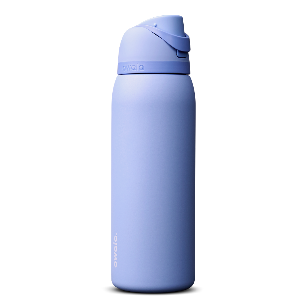 Owala FreeSip 24oz in Out of the Blue, periwinkle blue insulated bottle with matching blue-lavender flip cap and carry loop