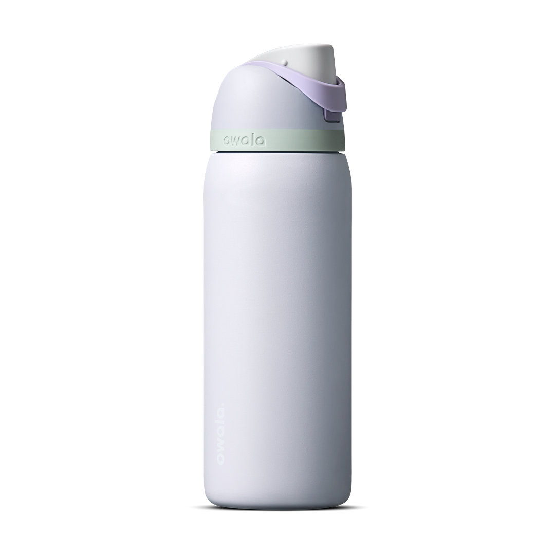 Owala FreeSip 24oz in Out of the Blue, periwinkle blue insulated bottle with matching blue-lavender flip cap and carry loop