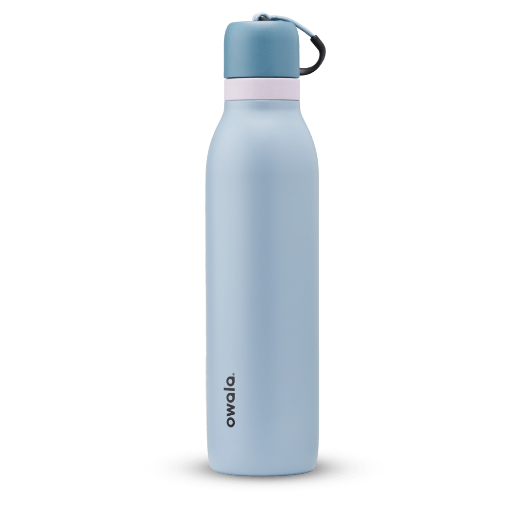 FreeSip Twist 24oz, coral pink body with orange-red lid and purple band; slim insulated bottle